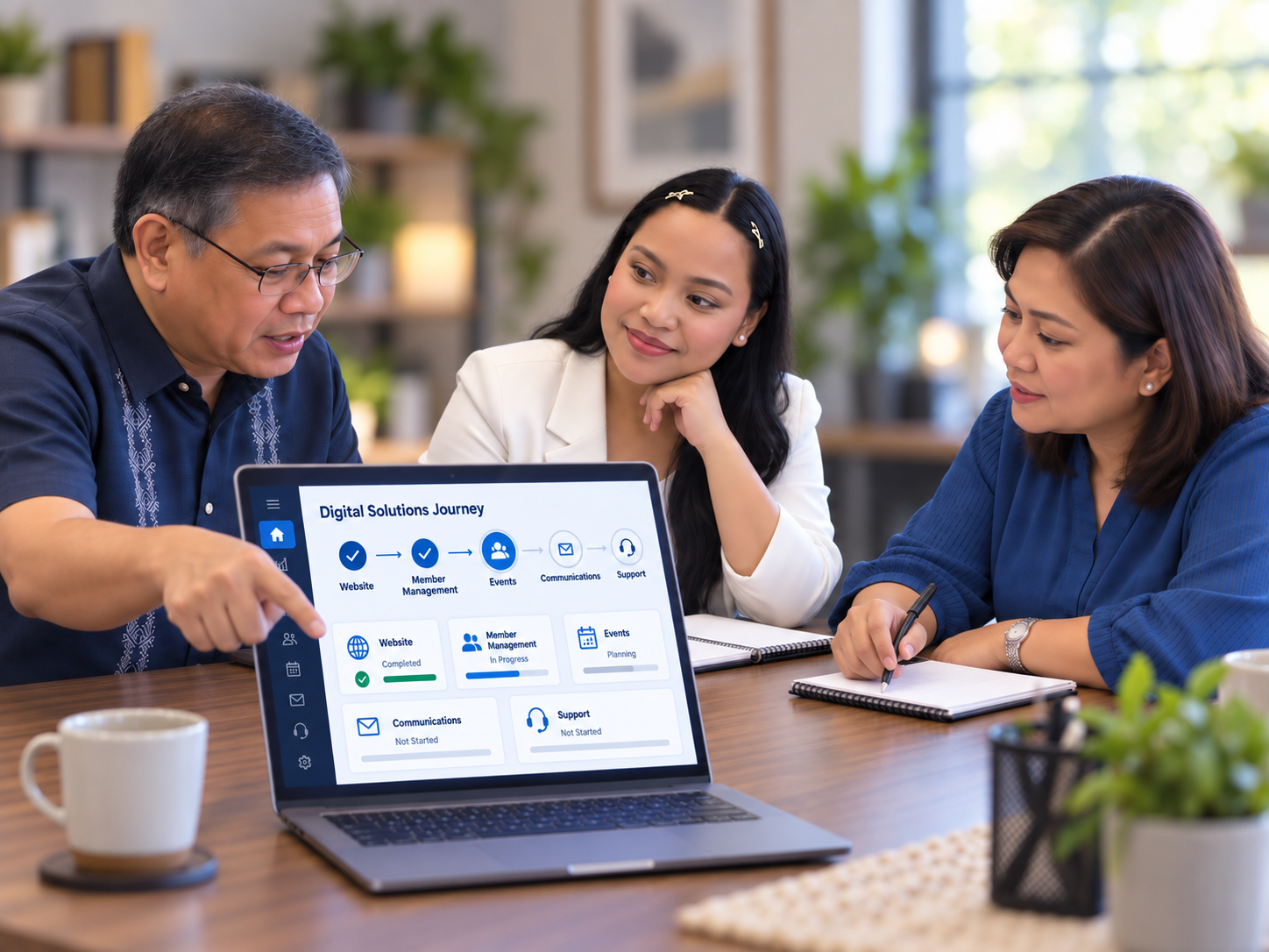 A Filipino consultant and church leaders reviewing a digital solutions workflow on a laptop